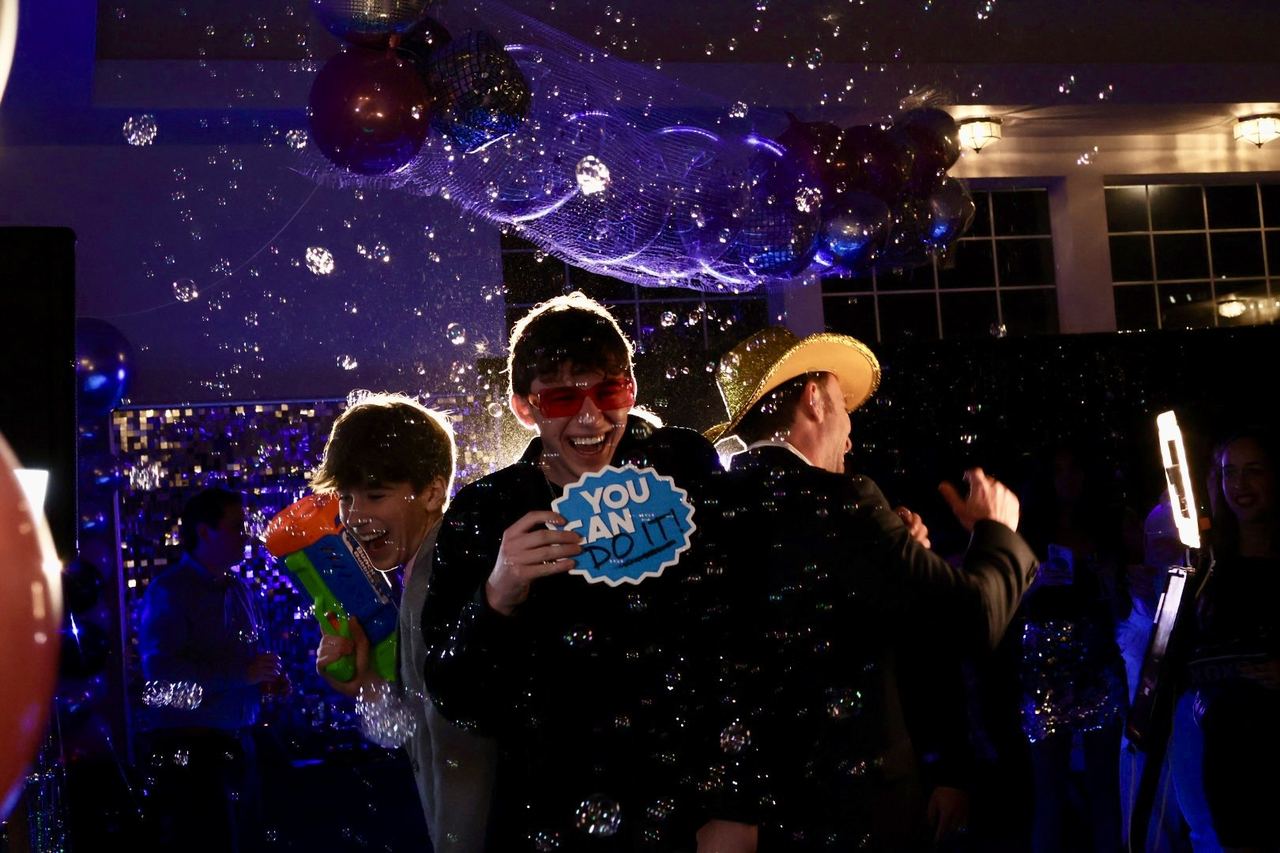 Guests laughing with props in a Zarco photo booth