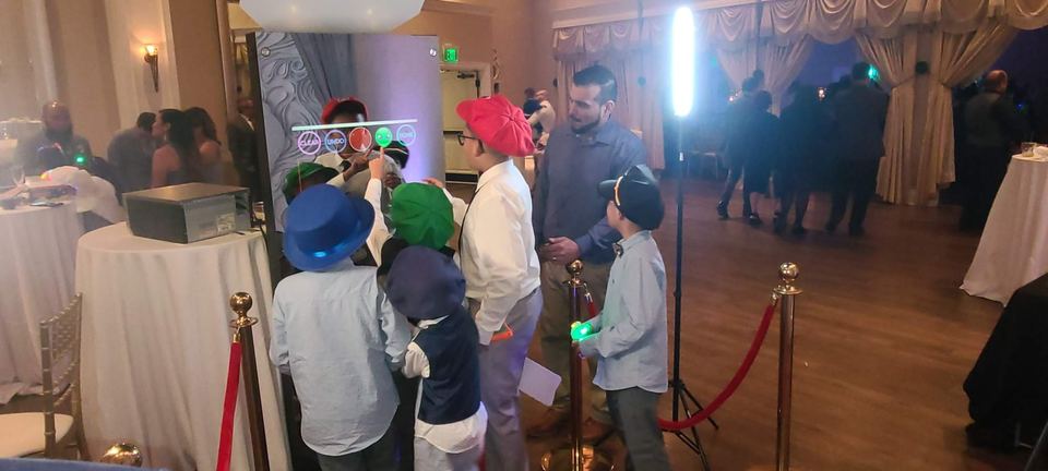 Kids posing with props at the photo booth